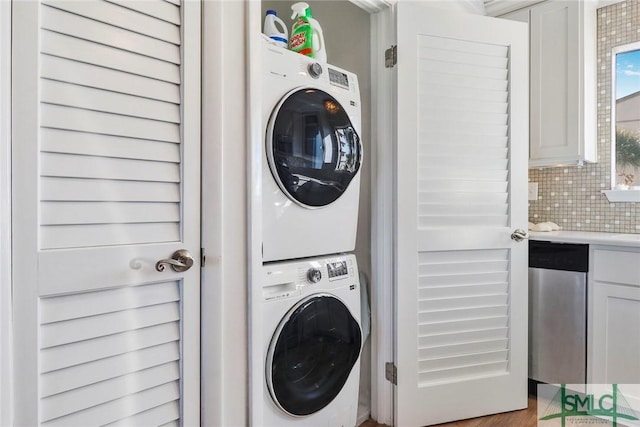 laundry room featuring stacked washer / drying machine