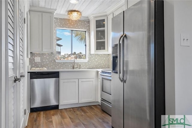 kitchen with white cabinets, stainless steel appliances, dark hardwood / wood-style flooring, and sink