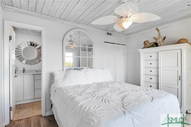 bedroom with dark wood-type flooring, crown molding, ceiling fan, and wood ceiling