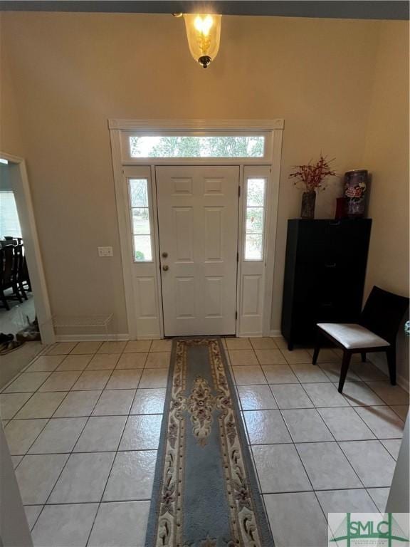 foyer with light tile patterned flooring and a healthy amount of sunlight