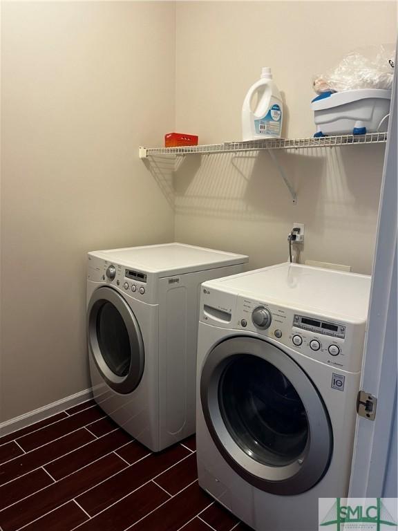 clothes washing area with washer and clothes dryer