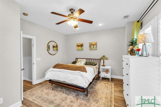 bedroom with ceiling fan and light hardwood / wood-style floors