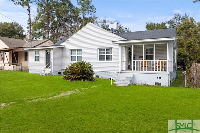 back of house featuring a yard and covered porch