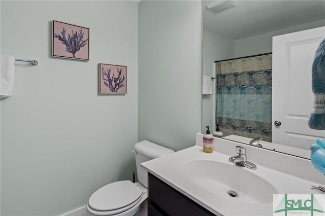 bathroom featuring toilet and vanity