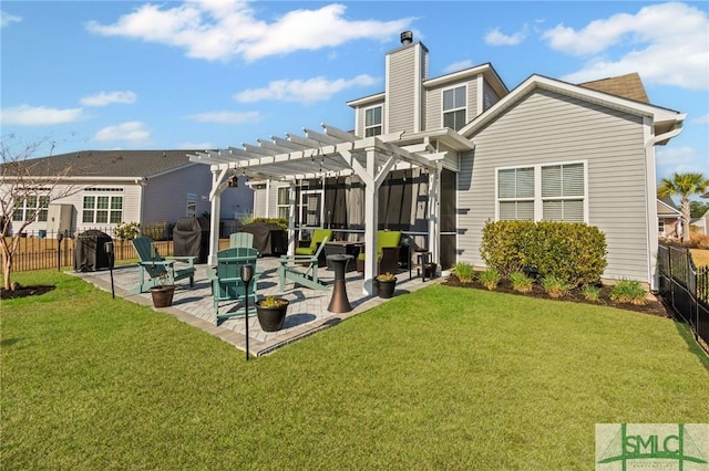 back of property featuring a patio area, a yard, and a pergola