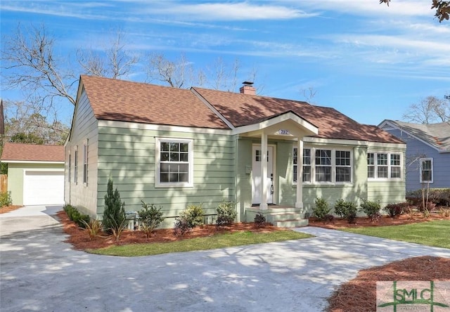 view of front of house featuring a garage and an outdoor structure