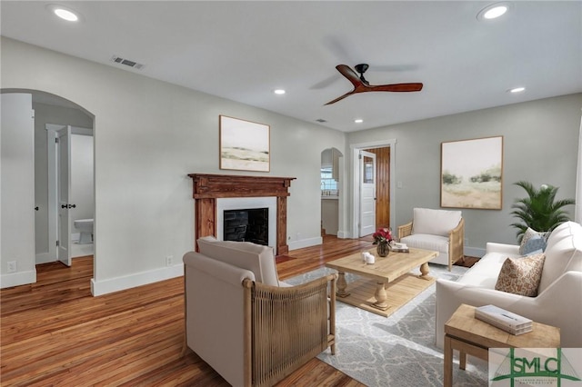 living room featuring hardwood / wood-style flooring and ceiling fan