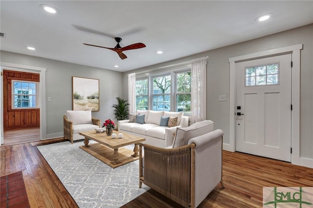 living room with ceiling fan and dark hardwood / wood-style floors