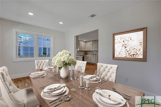 dining room with hardwood / wood-style flooring