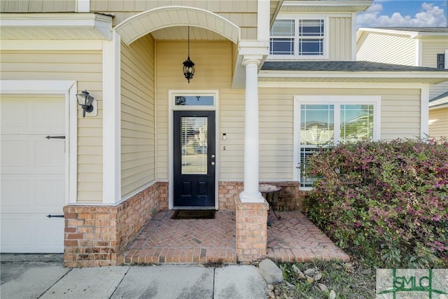 doorway to property with a garage