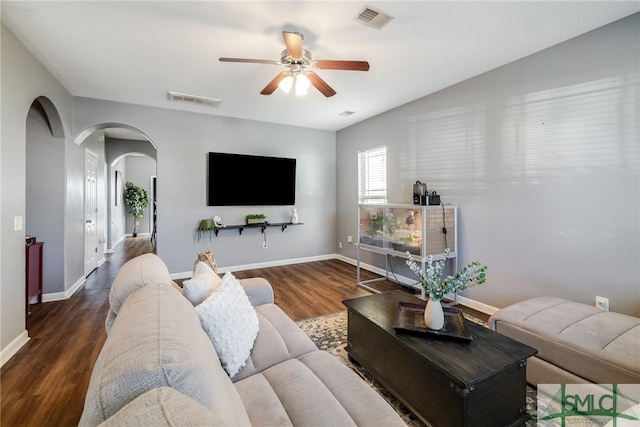 living room with ceiling fan and dark hardwood / wood-style floors