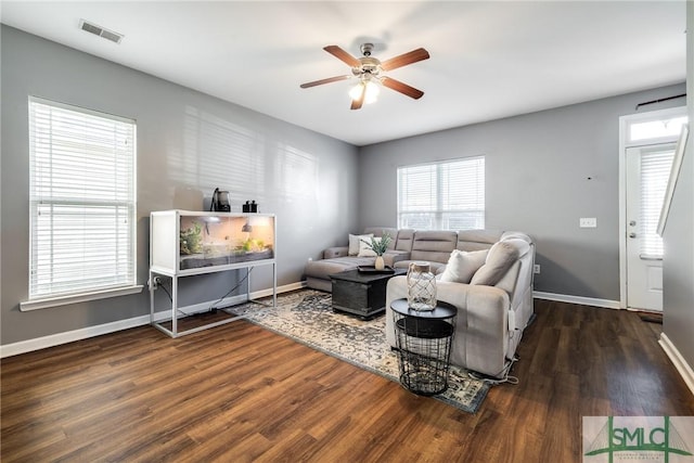 living room featuring dark hardwood / wood-style floors and ceiling fan