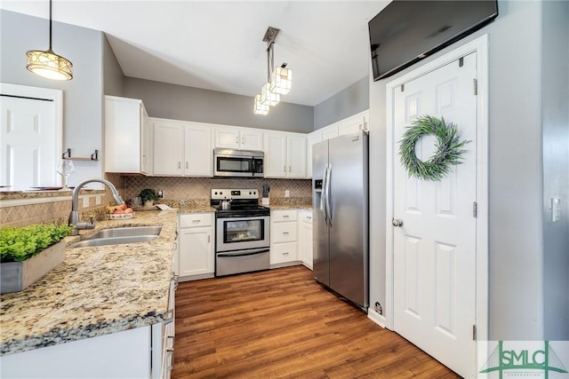 kitchen featuring hanging light fixtures, sink, tasteful backsplash, appliances with stainless steel finishes, and white cabinets