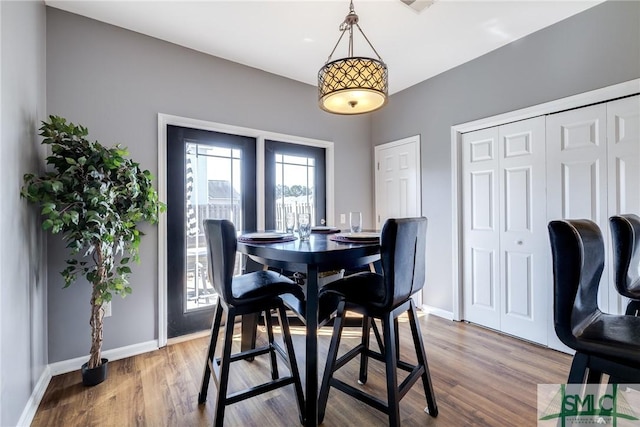 dining area with hardwood / wood-style floors