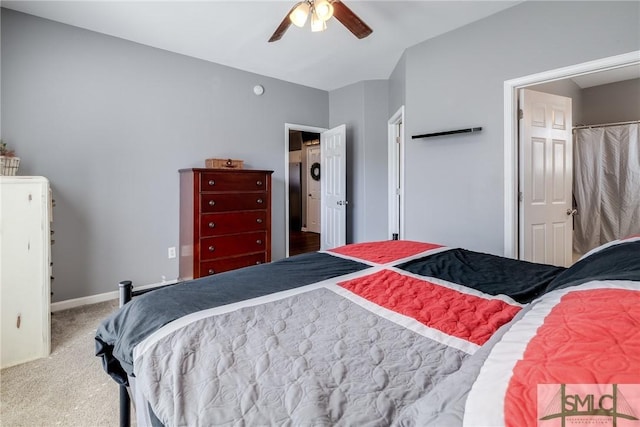 carpeted bedroom with vaulted ceiling and ceiling fan