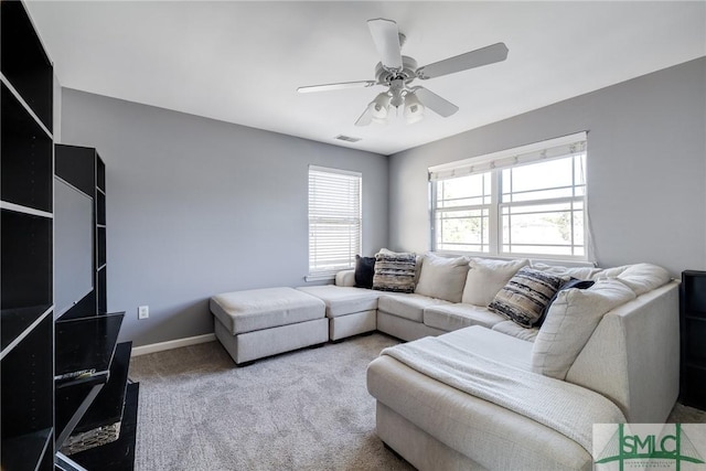 carpeted living room featuring ceiling fan