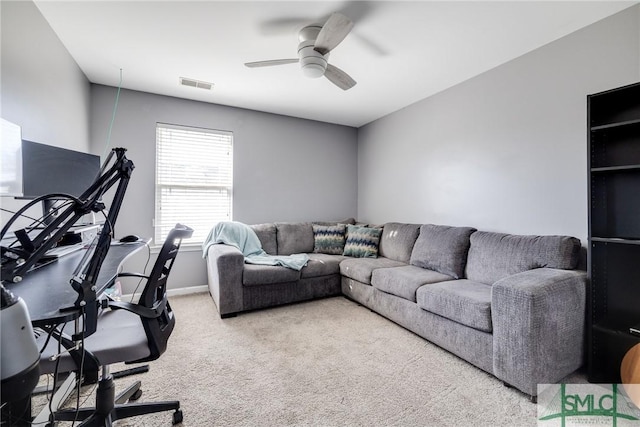 carpeted living room with ceiling fan