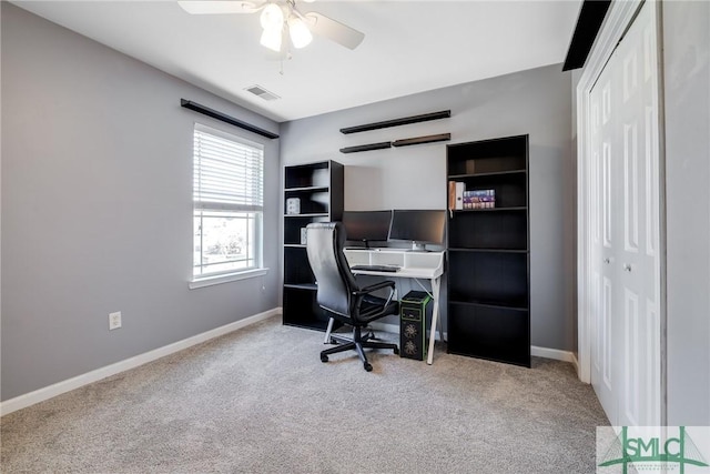 office space featuring ceiling fan and light colored carpet