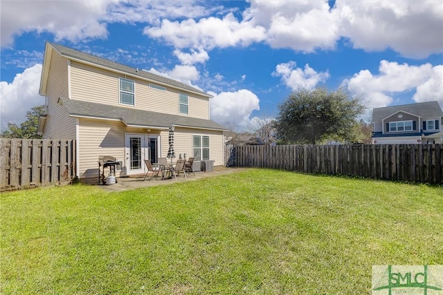 back of property with a patio and a yard