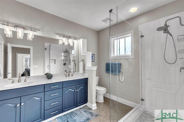 bathroom with toilet, tile patterned floors, vanity, and walk in shower