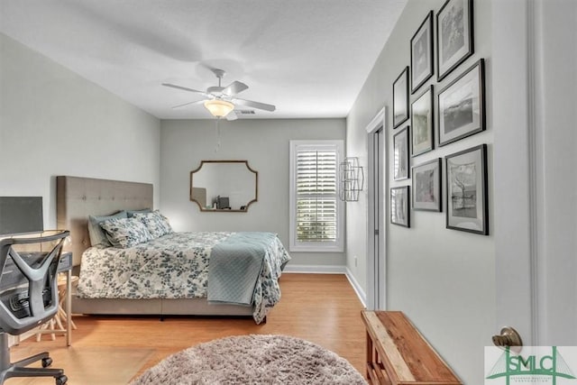 bedroom with light wood-type flooring and ceiling fan