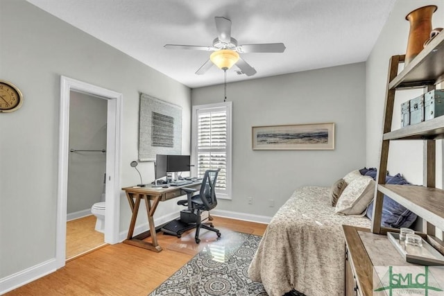 bedroom featuring connected bathroom, ceiling fan, and wood-type flooring