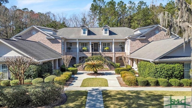 view of property with a front lawn and a porch