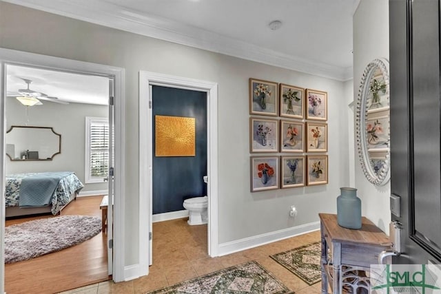 interior space featuring light tile patterned floors, ceiling fan, and ornamental molding