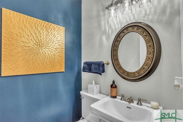 bathroom featuring sink and toilet