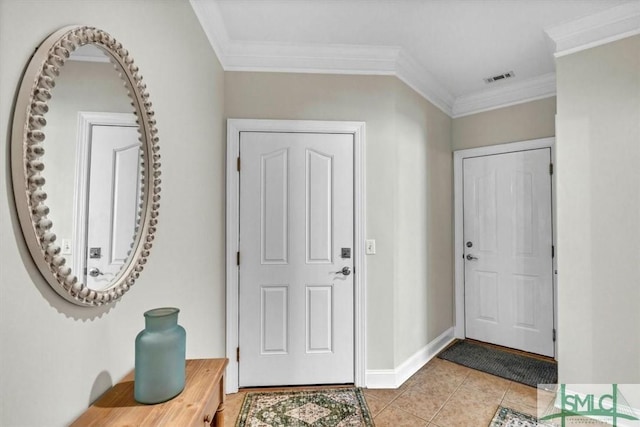 tiled entrance foyer featuring crown molding