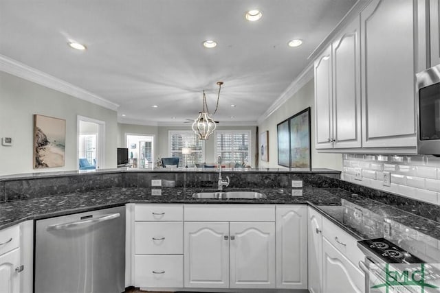 kitchen with sink, appliances with stainless steel finishes, white cabinets, and dark stone counters