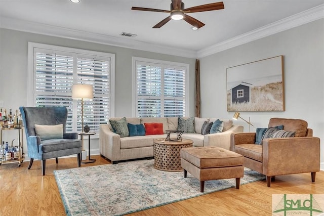 living room featuring ornamental molding, hardwood / wood-style flooring, and ceiling fan