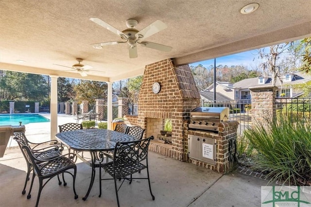 view of patio / terrace featuring ceiling fan, a community pool, a grill, and an outdoor brick fireplace