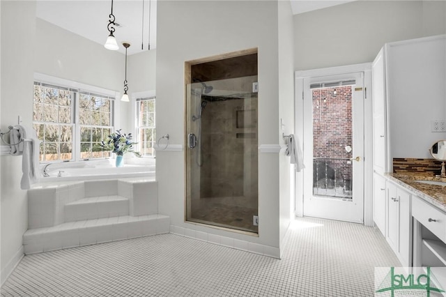 bathroom with independent shower and bath, tile patterned flooring, and vanity