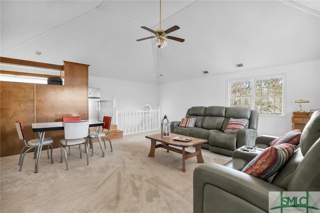 carpeted living room featuring ceiling fan and high vaulted ceiling