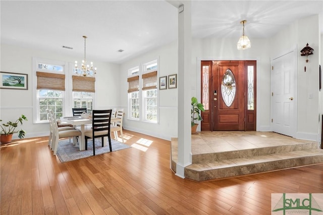 entryway featuring light hardwood / wood-style flooring and a notable chandelier