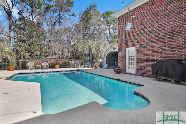 view of pool with a patio and area for grilling