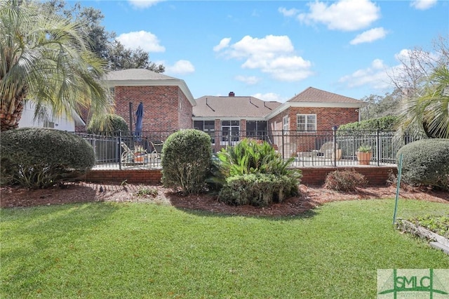 rear view of property with a lawn