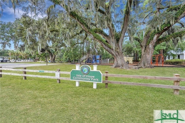 view of property's community with a lawn and a playground