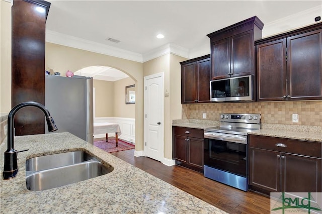 kitchen featuring sink, appliances with stainless steel finishes, and light stone counters