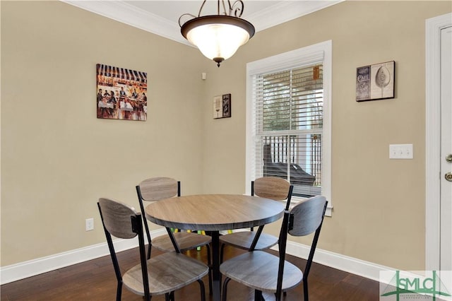 dining room featuring dark hardwood / wood-style flooring and crown molding