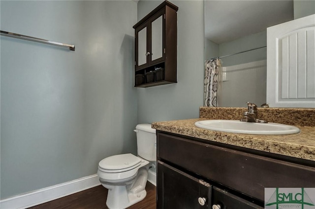 bathroom with hardwood / wood-style flooring, vanity, toilet, and a shower with shower curtain