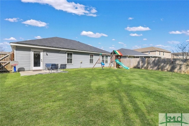 back of property with a patio, a playground, and a lawn