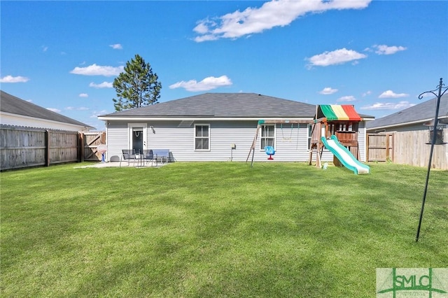 rear view of house featuring a patio area, a playground, and a yard