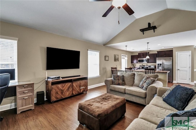 living room with ceiling fan, vaulted ceiling, and dark wood-type flooring