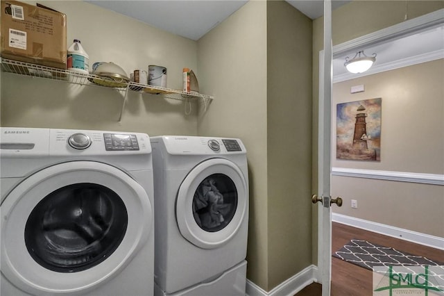 laundry room featuring washing machine and dryer and dark wood-type flooring