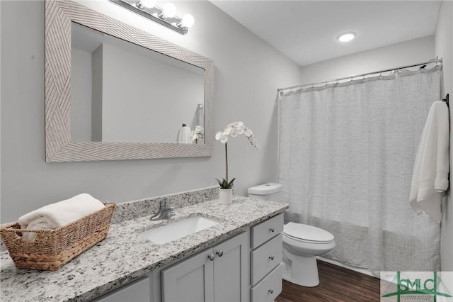 full bath with vanity, toilet, and wood finished floors