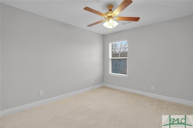 empty room with light carpet, ceiling fan, visible vents, and baseboards