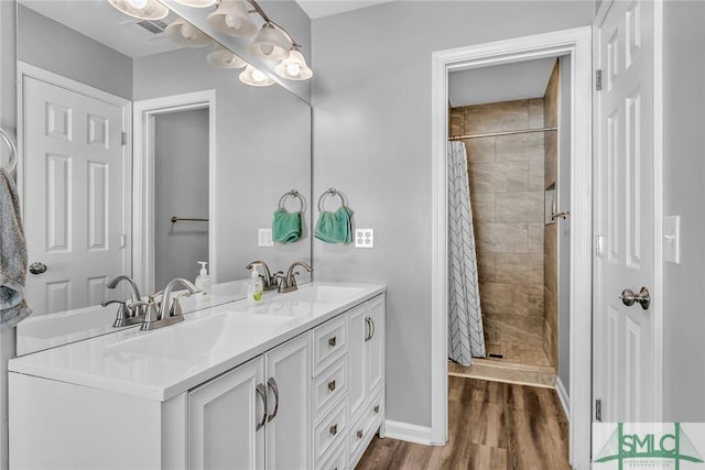 bathroom featuring hardwood / wood-style floors, a shower with shower curtain, and vanity