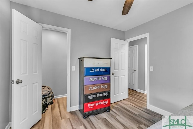 bedroom featuring light wood-type flooring and ceiling fan